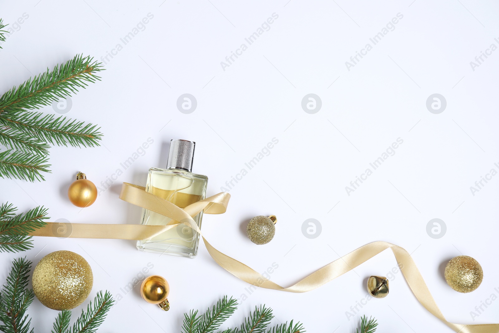 Photo of Christmas composition with perfume bottle on white background, flat lay. Space for text