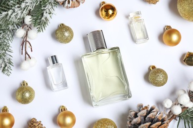 Christmas composition with perfume bottles on white background, flat lay