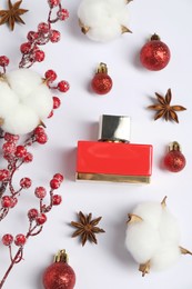 Christmas composition with perfume bottle on white background, flat lay