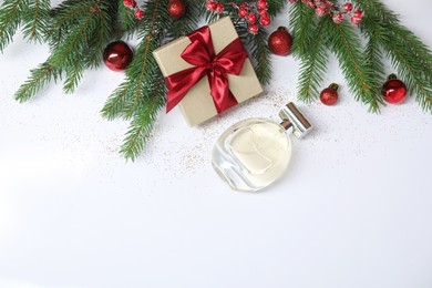 Photo of Christmas composition with perfume bottle on white background, flat lay