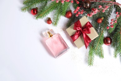 Photo of Christmas composition with perfume bottle on white background, flat lay