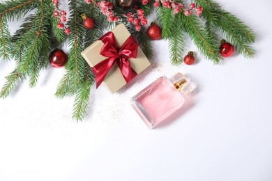 Christmas composition with perfume bottle on white background, flat lay