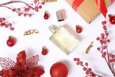 Christmas composition with perfume bottle on white background, flat lay