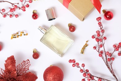 Photo of Christmas composition with perfume bottle on white background, flat lay