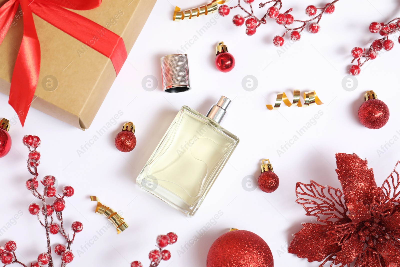 Photo of Christmas composition with perfume bottle on white background, flat lay