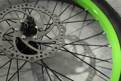 Bicycle wheel with tire on grey background, closeup