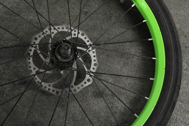 Bicycle wheel with tire on grey background, closeup