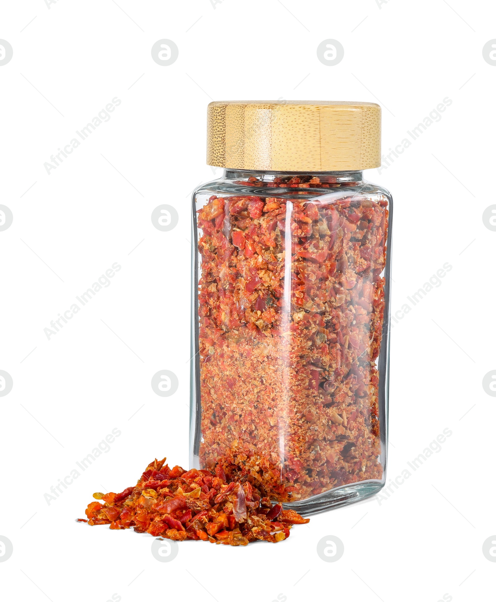 Photo of Red chili pepper flakes in glass jar isolated on white