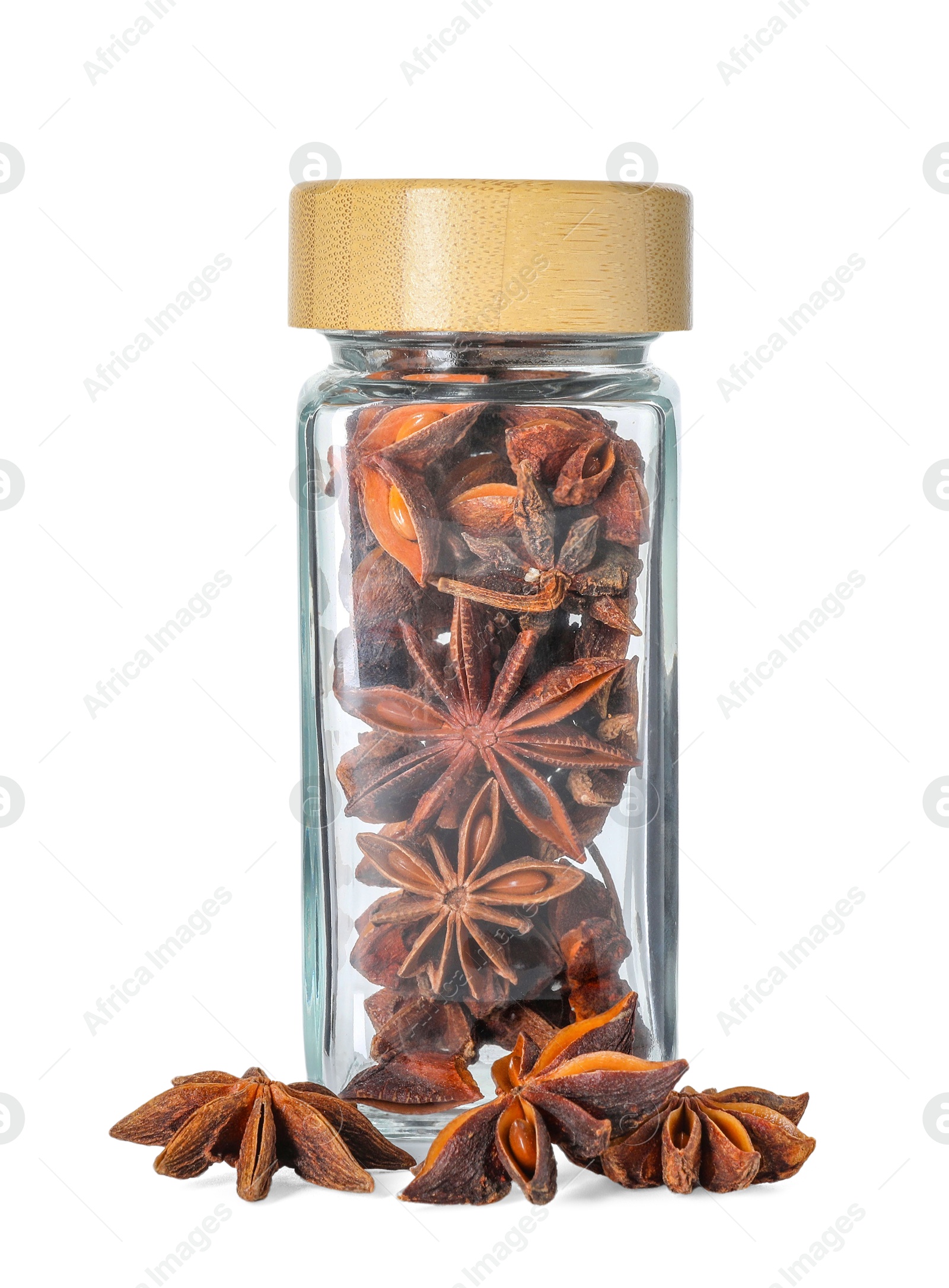 Photo of Anise stars in glass jar isolated on white