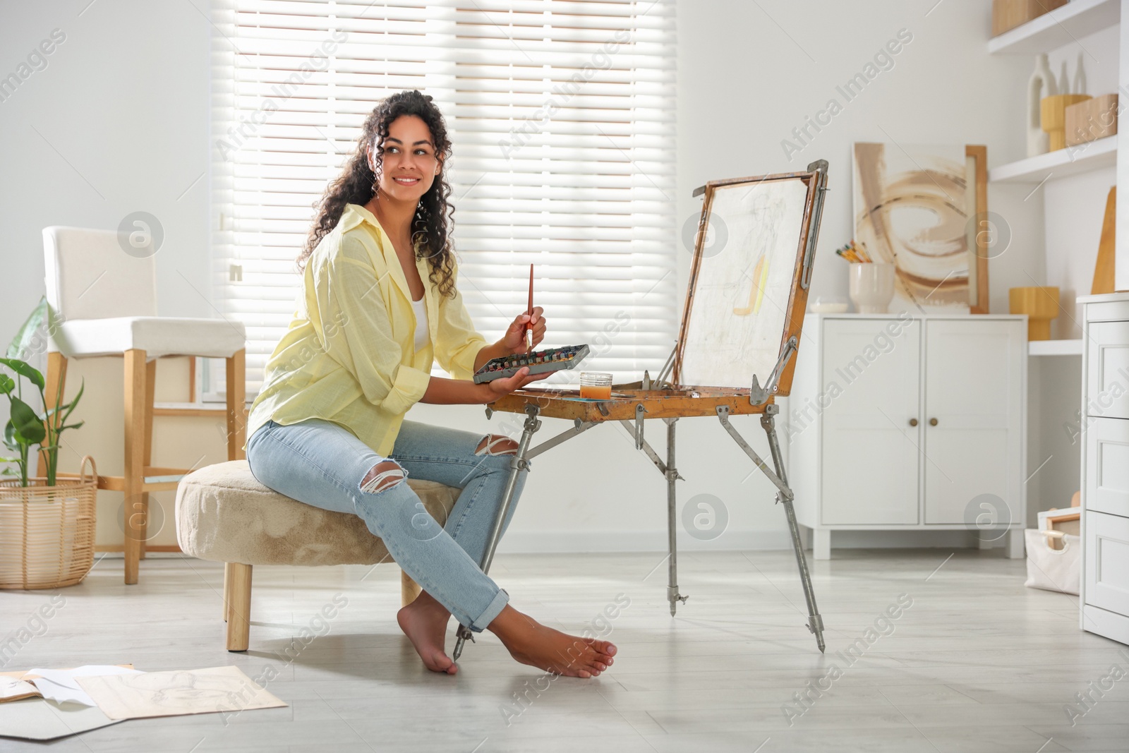 Photo of Smiling woman drawing picture in art studio