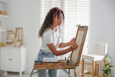 Photo of Beautiful woman drawing portrait with pencil in studio