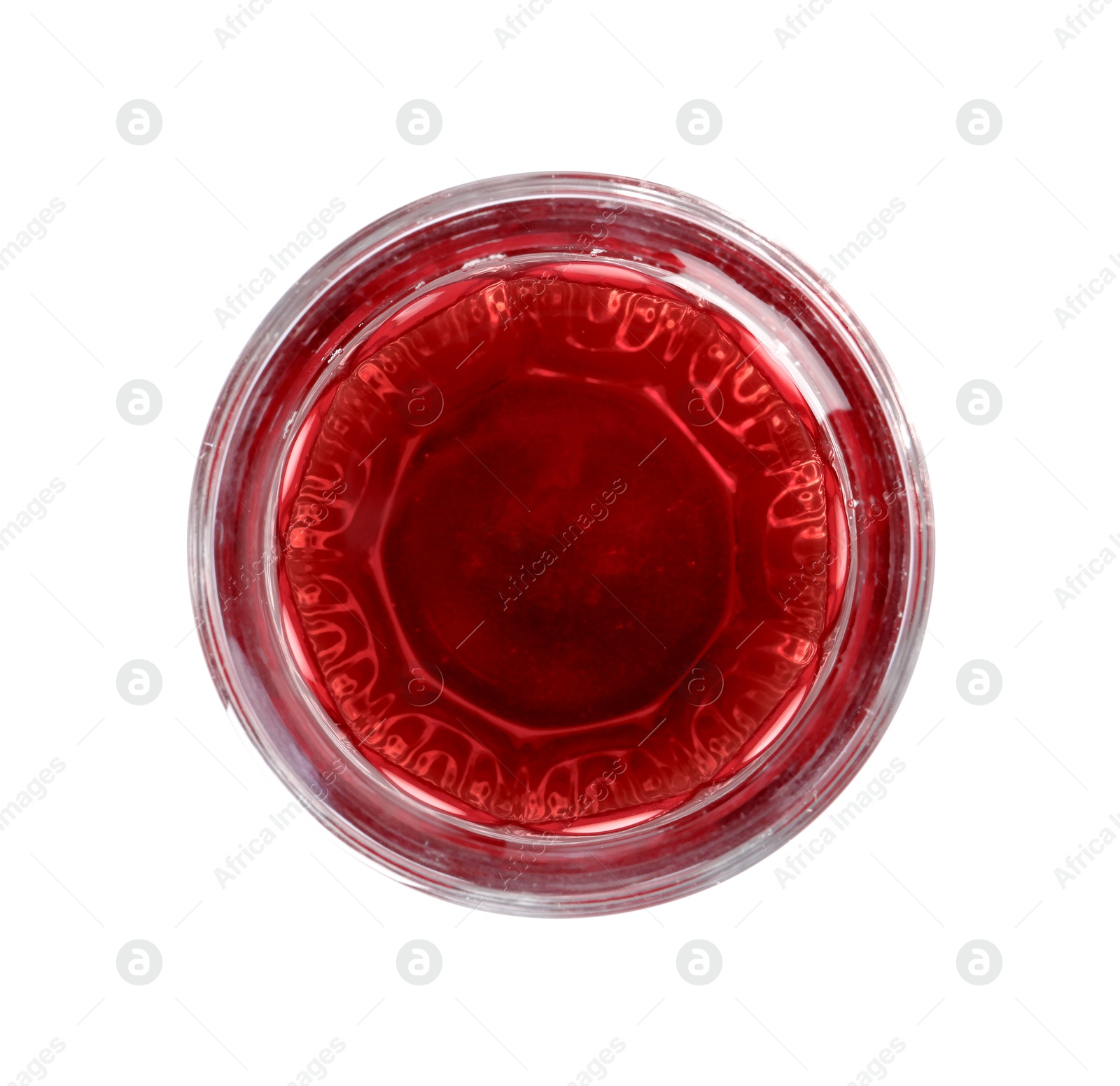 Photo of Tasty grape juice in glass isolated on white, top view