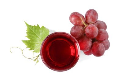 Ripe grapes and glass of tasty juice isolated on white, top view