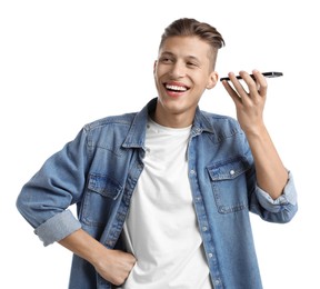 Young man with smartphone listening to voice message on white background