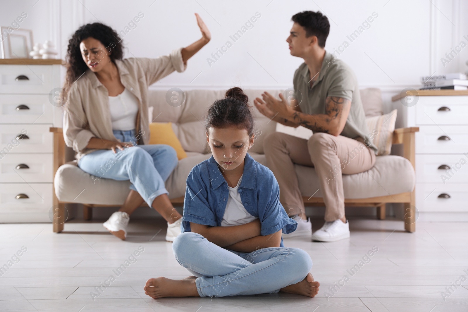 Photo of Divorce concept. Angry couple arguing at home, focus on their sad daughter