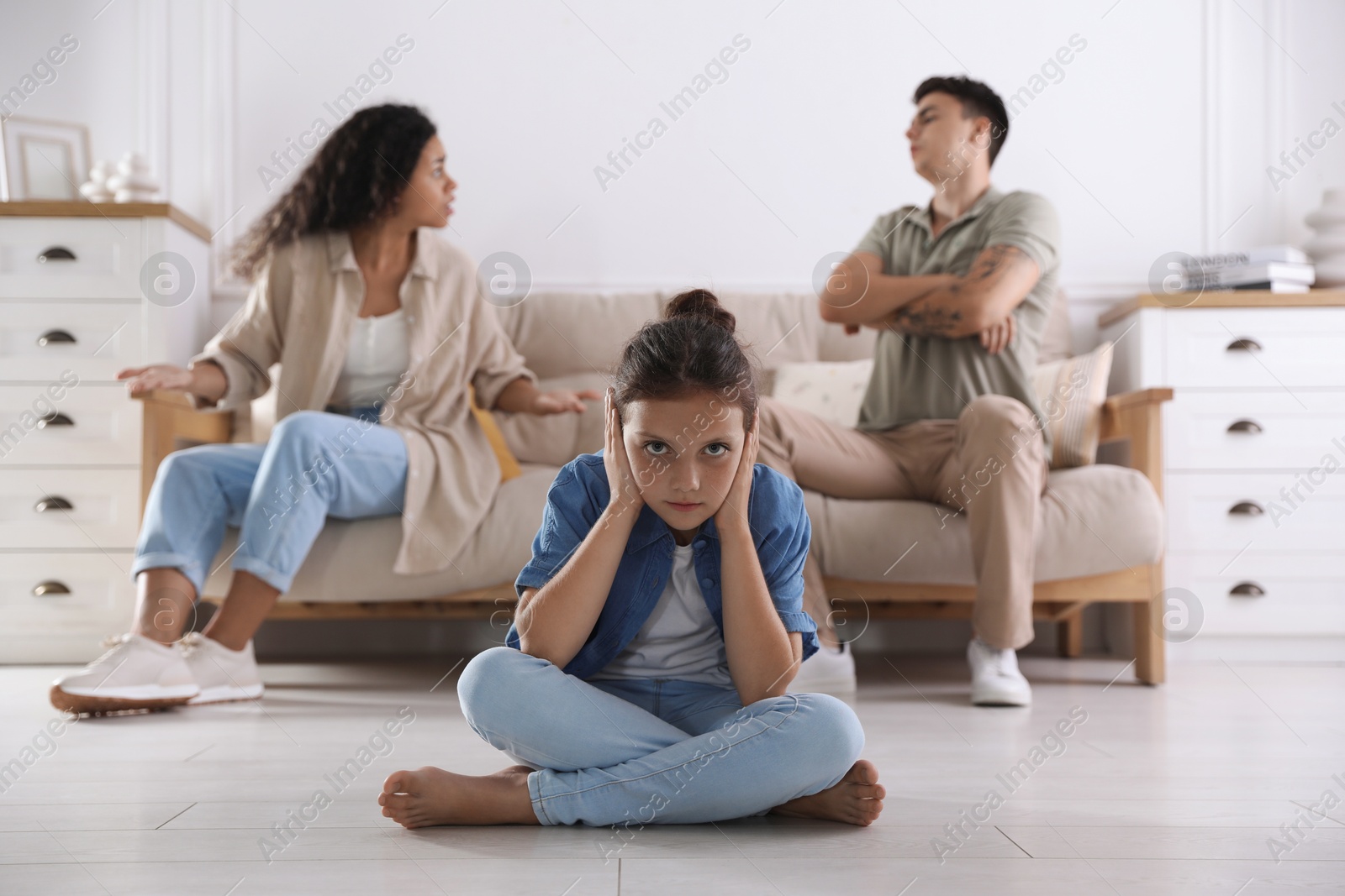 Photo of Divorce concept. Angry couple arguing at home, focus on their sad daughter