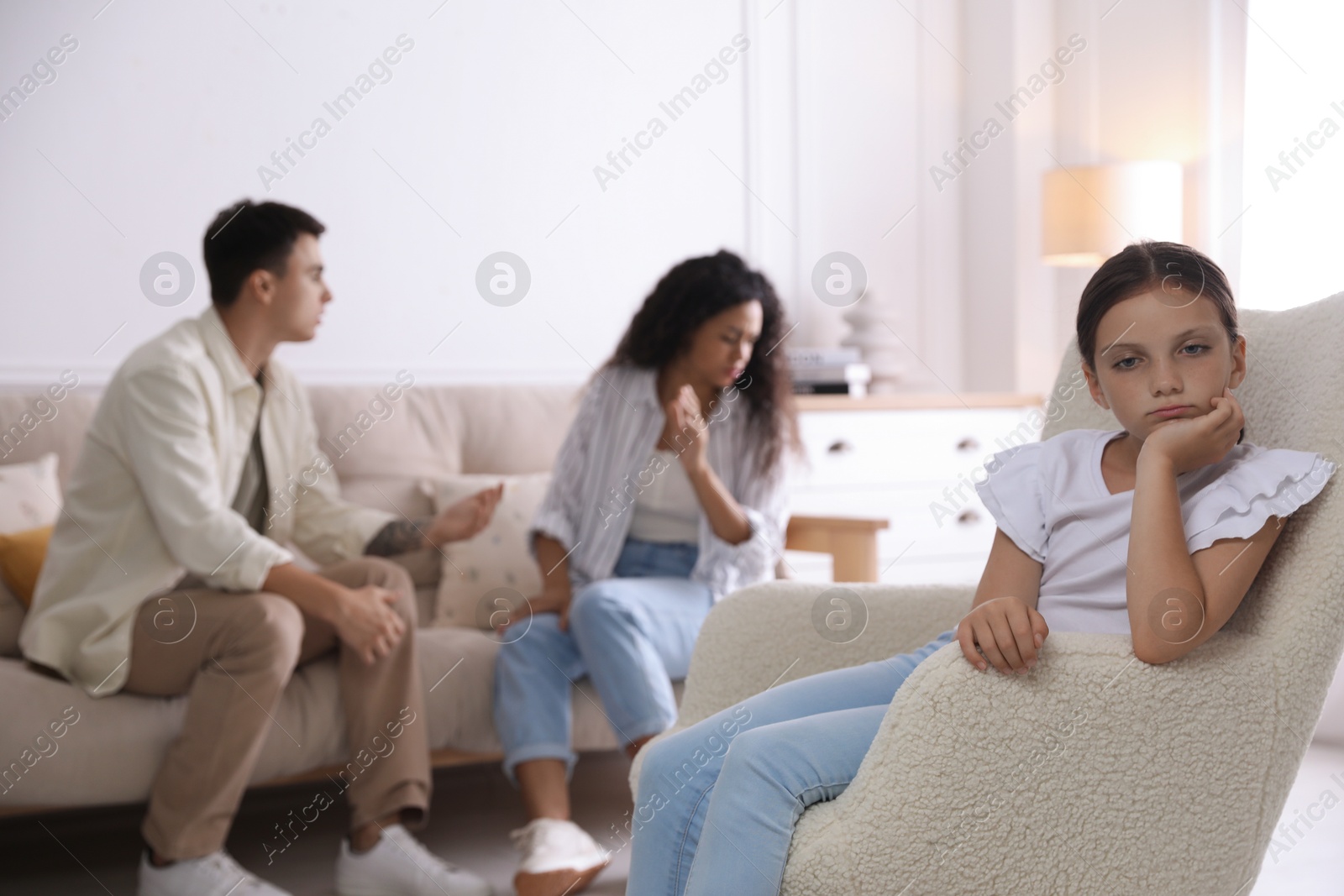 Photo of Divorce concept. Angry couple arguing at home, focus on their sad daughter