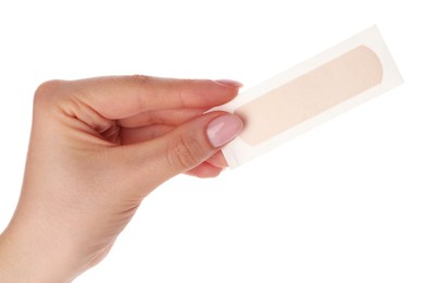 Photo of Woman holding medical adhesive bandage on white background, closeup