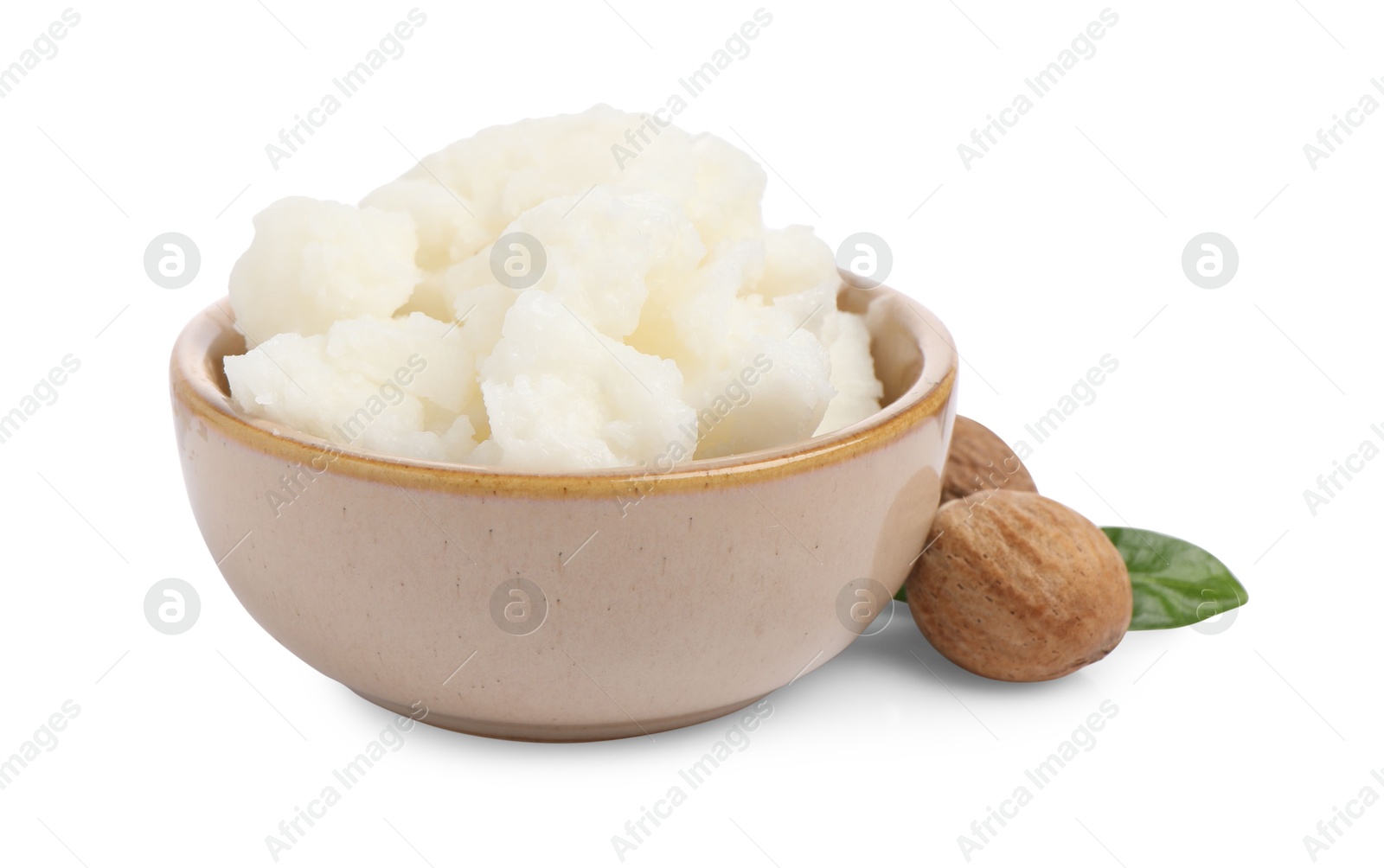 Photo of Shea butter in bowl and nuts isolated on white