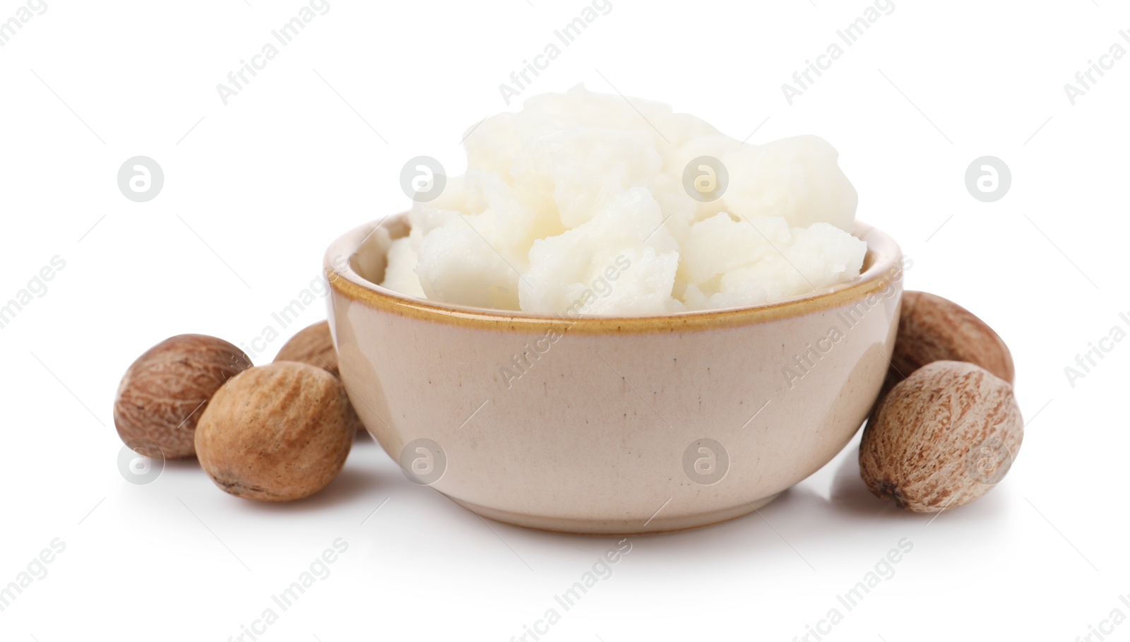 Photo of Shea butter in bowl and nuts isolated on white