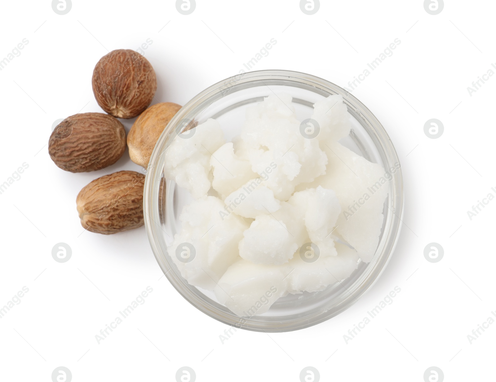 Photo of Shea butter in bowl and nuts isolated on white, top view