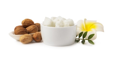 Shea butter in bowl, flower and nuts isolated on white