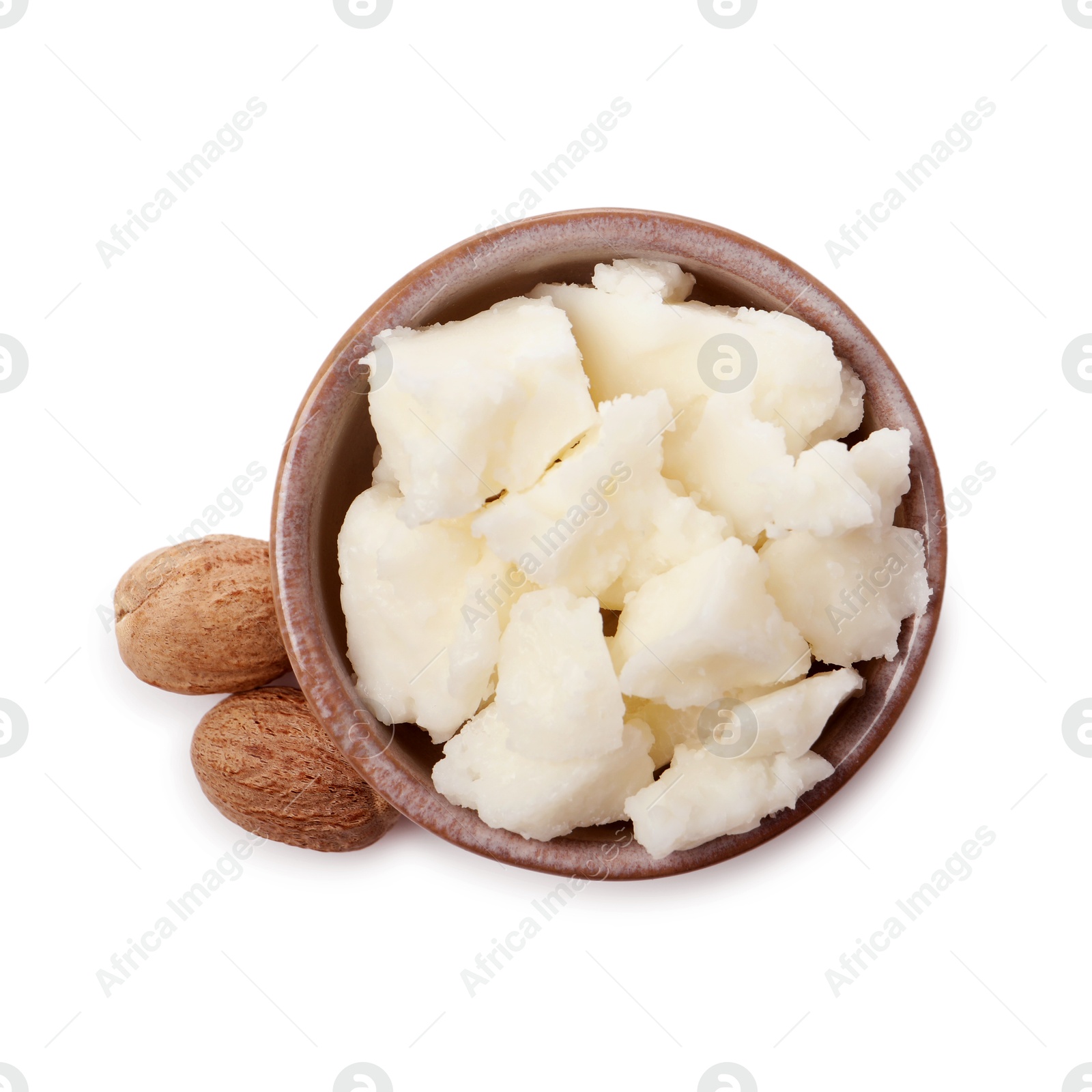 Photo of Shea butter in bowl and nuts isolated on white, top view