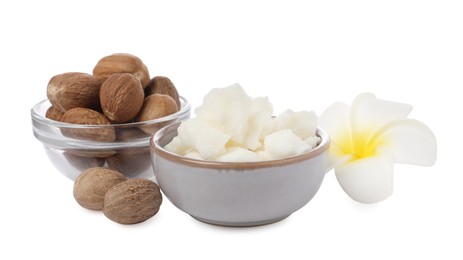 Photo of Shea butter in bowl, flower and nuts isolated on white