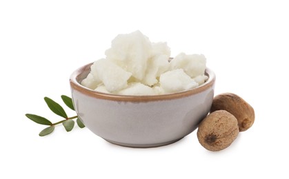 Photo of Shea butter in bowl and nuts isolated on white