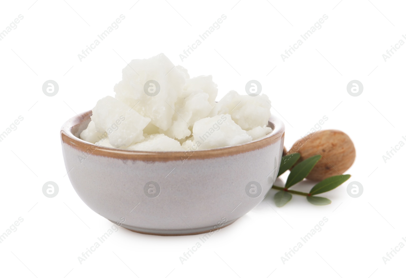 Photo of Shea butter in bowl and nuts isolated on white