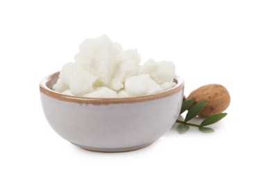 Photo of Shea butter in bowl and nuts isolated on white