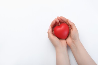 Photo of Woman holding red heart on white background, top view. Space for text