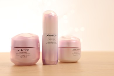 Photo of Leiden, Netherlands - June 11, 2024: Shiseido care cosmetic products on wooden table against light background, space for text