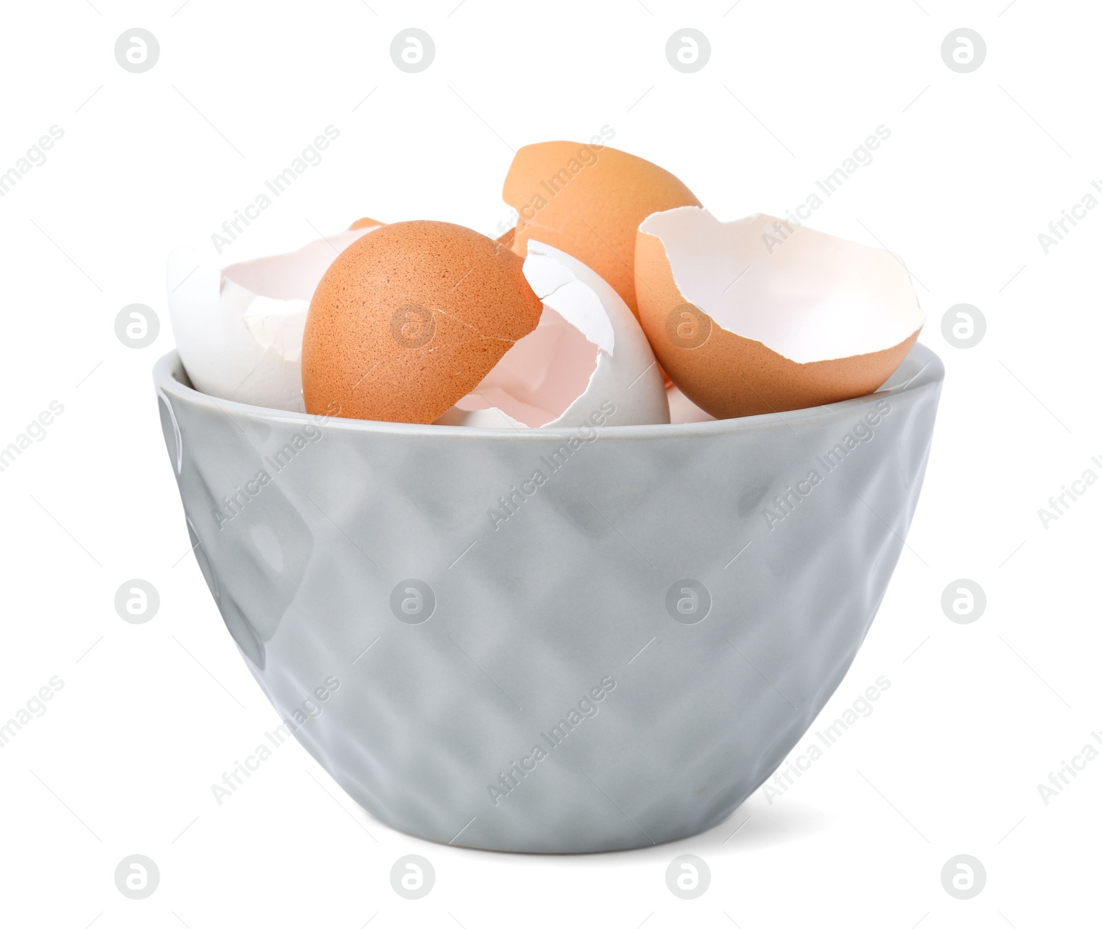 Photo of Broken eggshells in bowl isolated on white