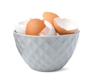 Photo of Broken eggshells in bowl isolated on white