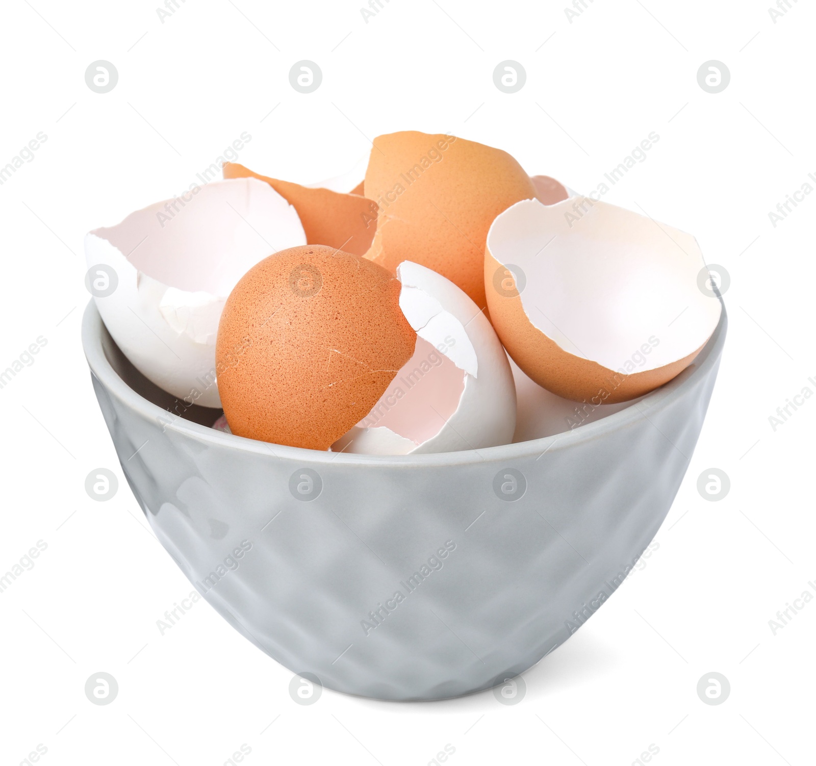 Photo of Broken eggshells in bowl isolated on white