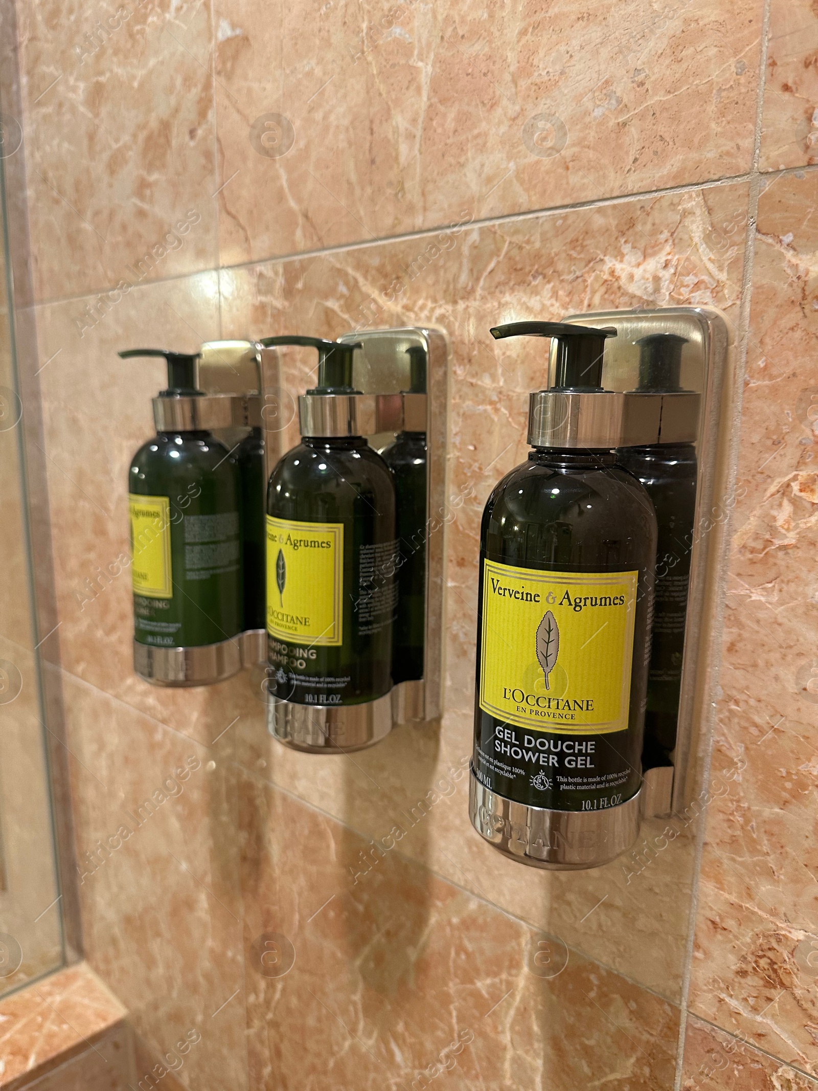 Photo of Berlin, Germany - July 2, 2024: Bottles with body care products on tiled wall in Regent Berlin Hotel bathroom