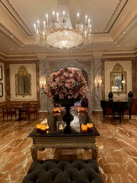 Berlin, Germany - July 1, 2024: Vase with beautiful flowers on mirrored table in Regent Berlin Hotel lobby