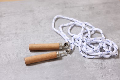 Photo of Skipping rope on grey table. Sports equipment