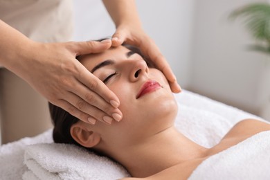 Attractive woman enjoying face massage, closeup. Beauty procedure