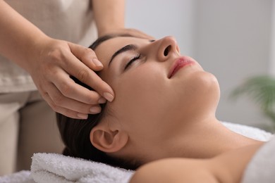 Attractive woman enjoying face massage, closeup. Beauty procedure