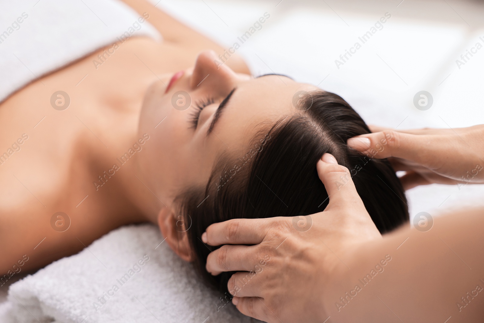 Photo of Attractive woman enjoying face massage, closeup. Beauty procedure