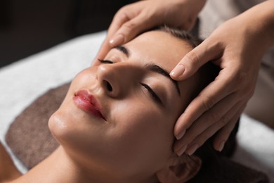 Photo of Attractive woman enjoying face massage, closeup. Beauty procedure