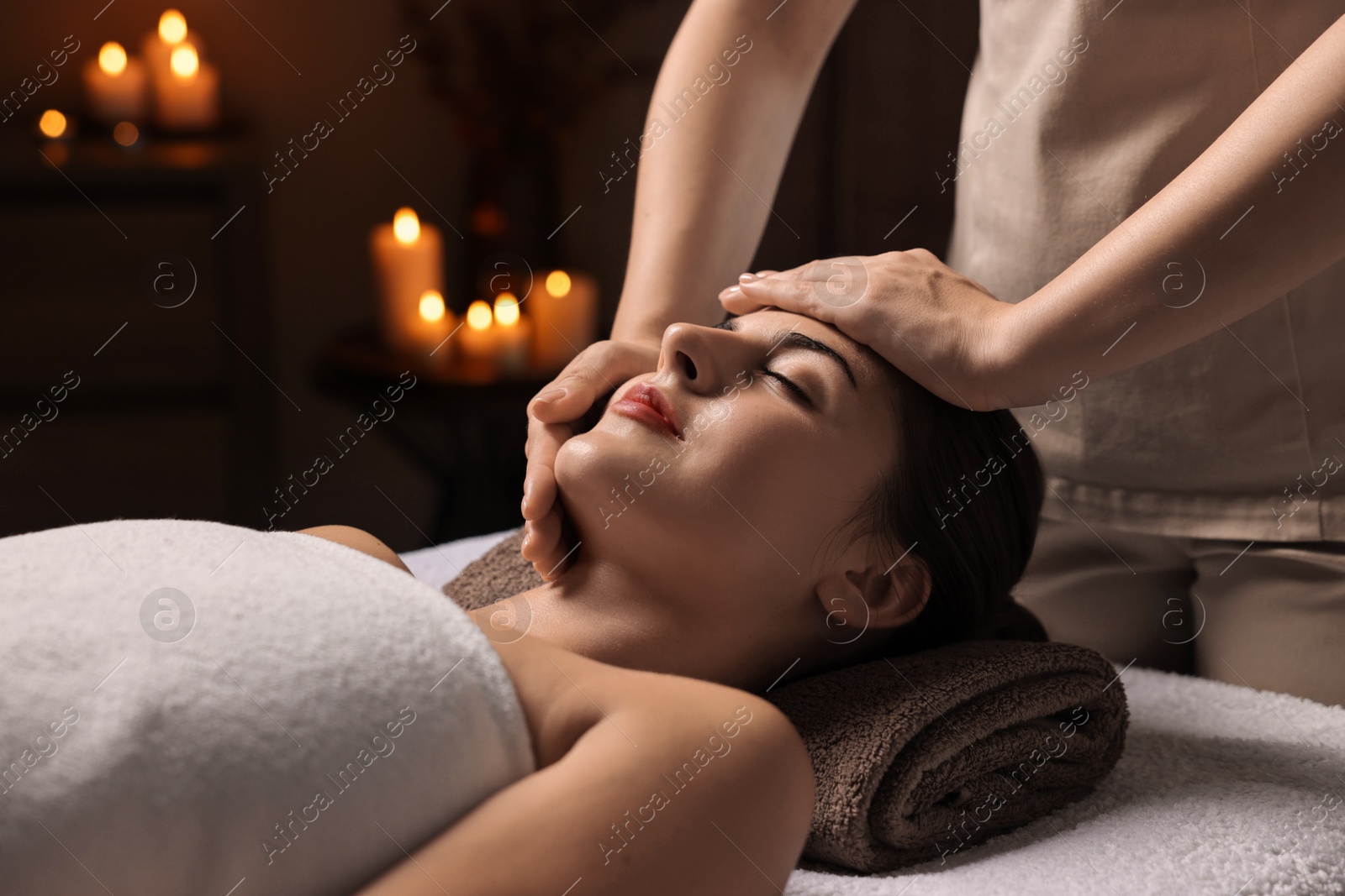 Photo of Attractive woman enjoying face massage, closeup. Beauty procedure