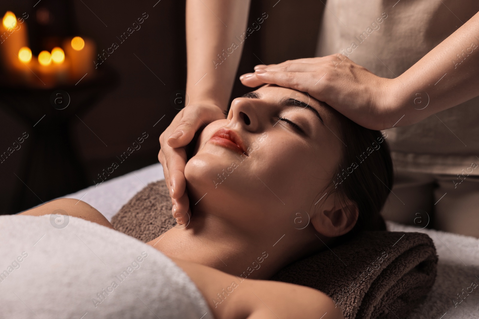 Photo of Attractive woman enjoying face massage, closeup. Beauty procedure