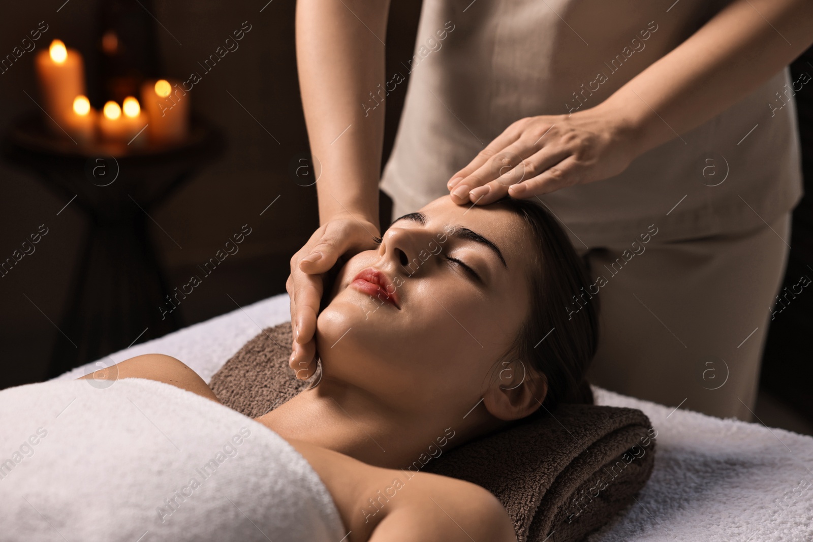 Photo of Attractive woman enjoying face massage, closeup. Beauty procedure