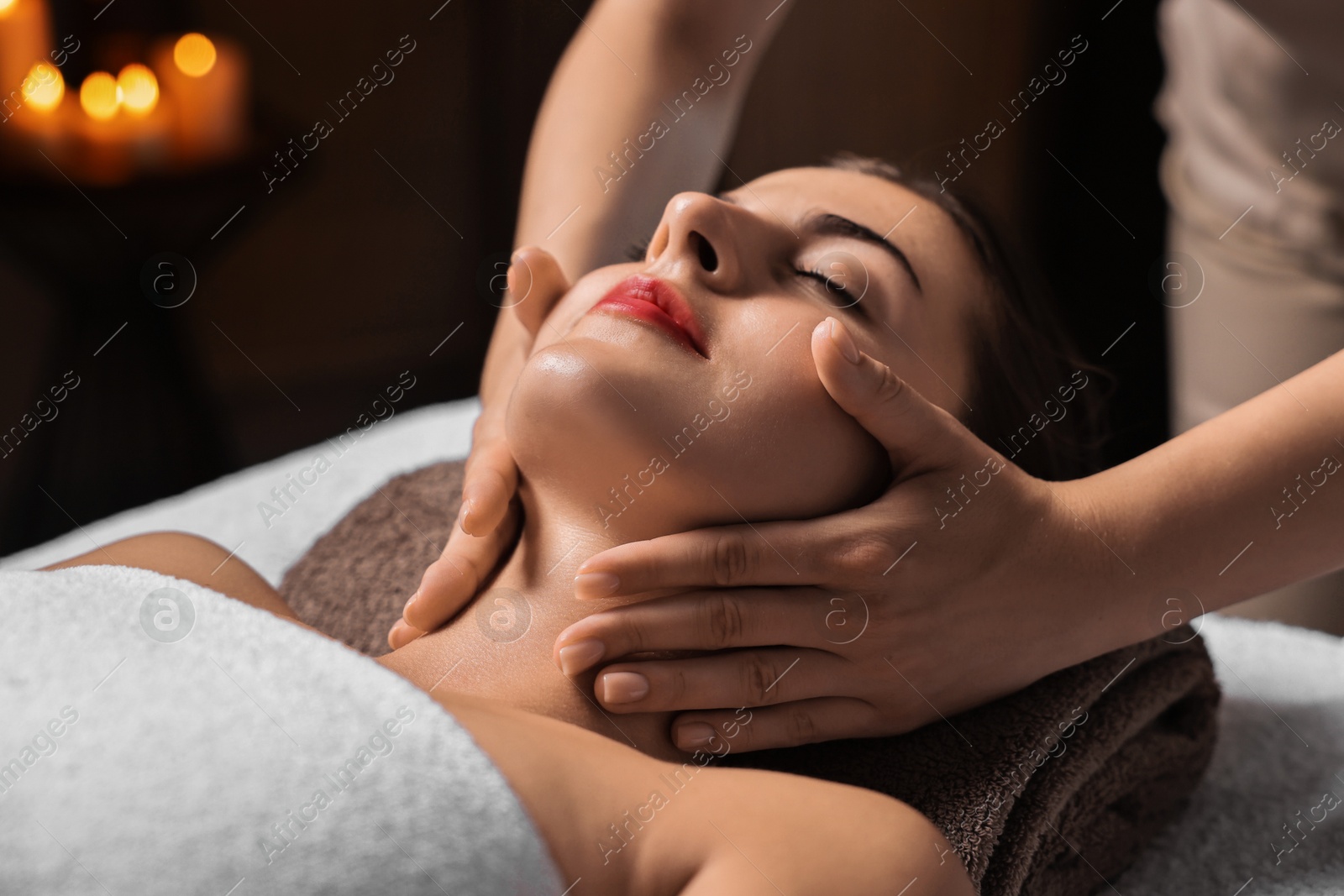 Photo of Attractive woman enjoying face massage, closeup. Beauty procedure