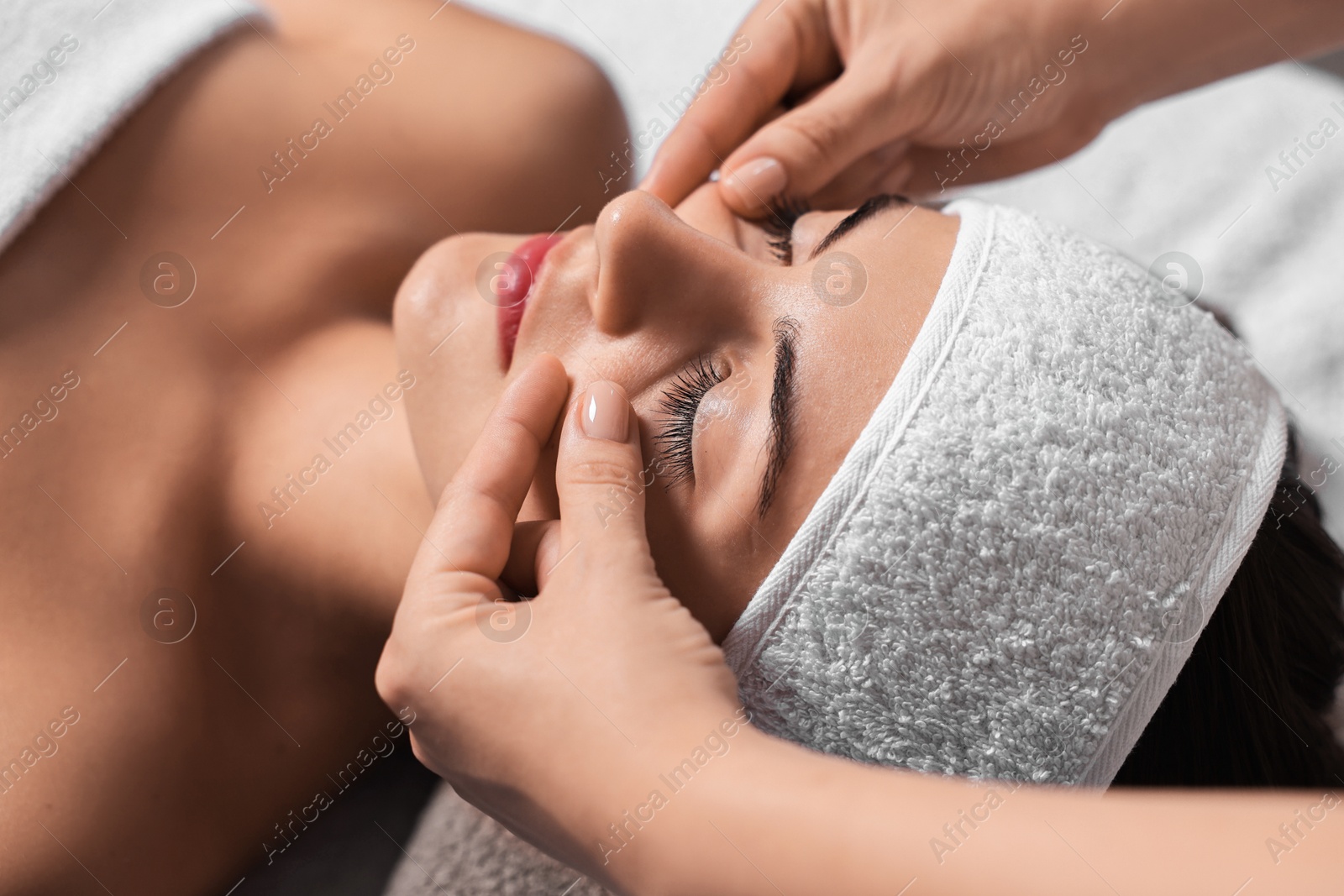 Photo of Attractive woman enjoying face massage, closeup. Beauty procedure