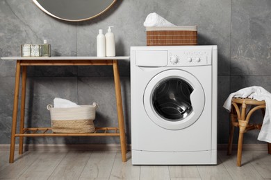 Photo of Washing machine, storage bench and chair indoors