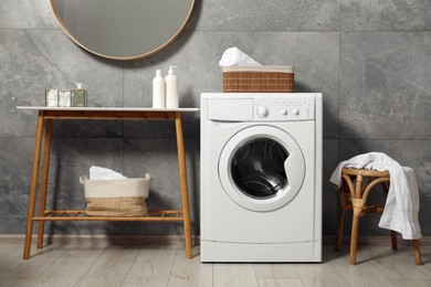 Photo of Washing machine, storage bench and chair indoors